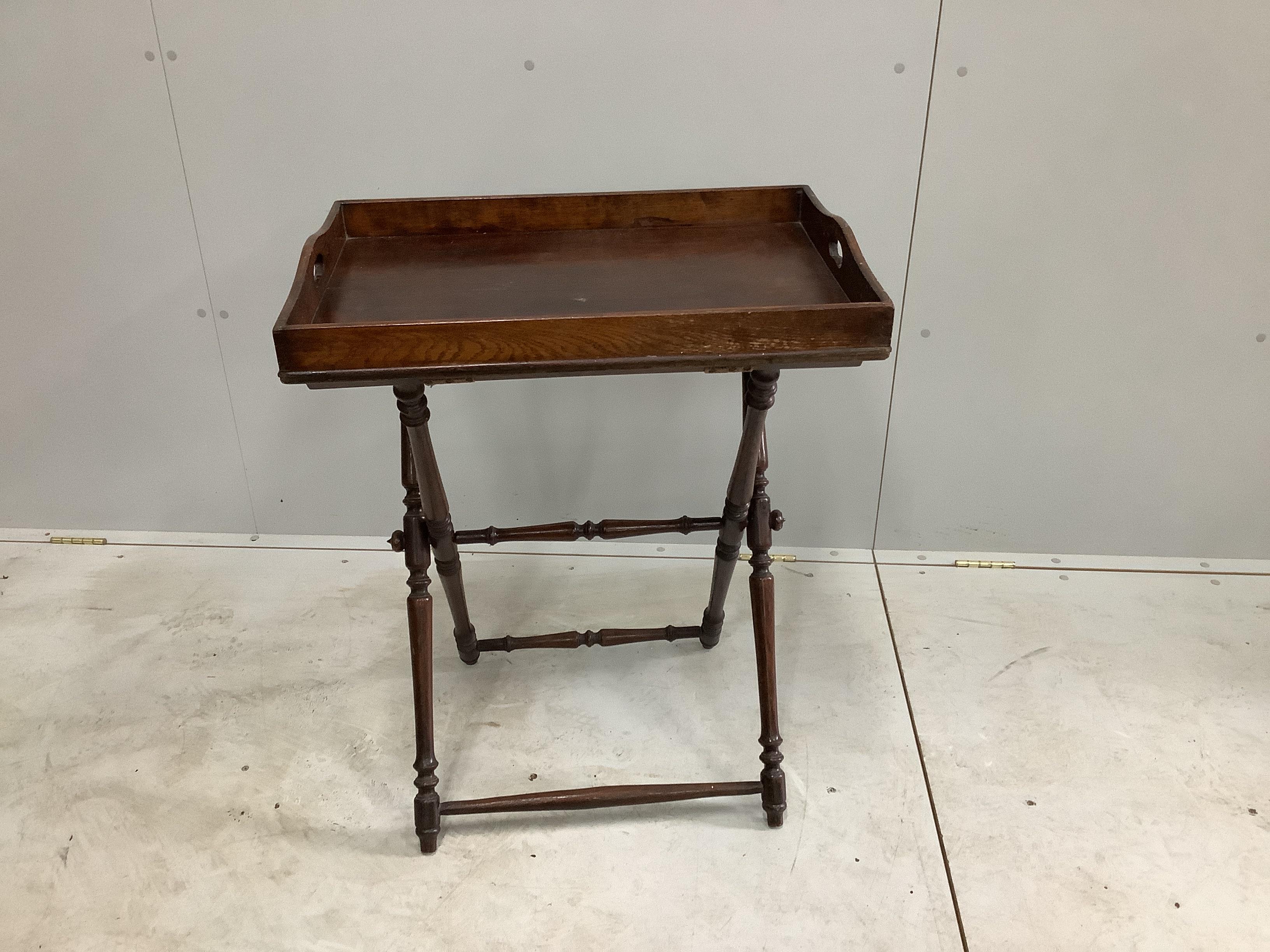 A late Victorian rectangular oak butler's tray on folding stand, width 65cm, depth 44cm, height 81cm